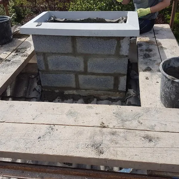 Chimney stack being rebuilt in blockwork on the roof, Global Roofing and Guttering, Dublin