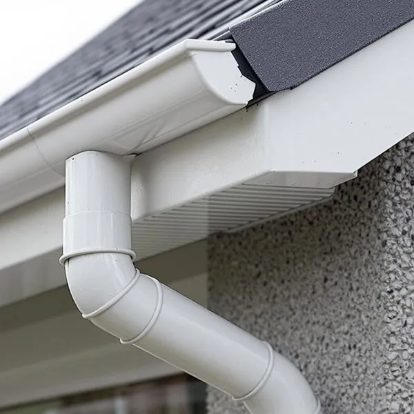 White uPVC gutter and downpipe at the eaves