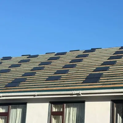 New slates going on over the battens on a rendered house, Global Roofing and Guttering, Dublin