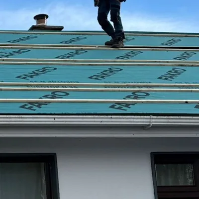 Roofer walking the new membrane and battens on a rendered house, Global Roofing and Guttering, Dublin