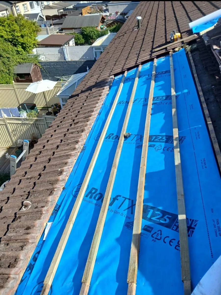 Estate house roof stripped to new membrane and battens beside the old tiles, Global Roofing and Guttering, Dublin